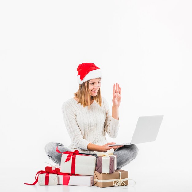 Woman in red Santa hat making video call