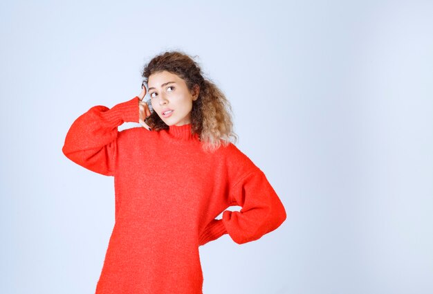 woman in a red shirt asking to call. 