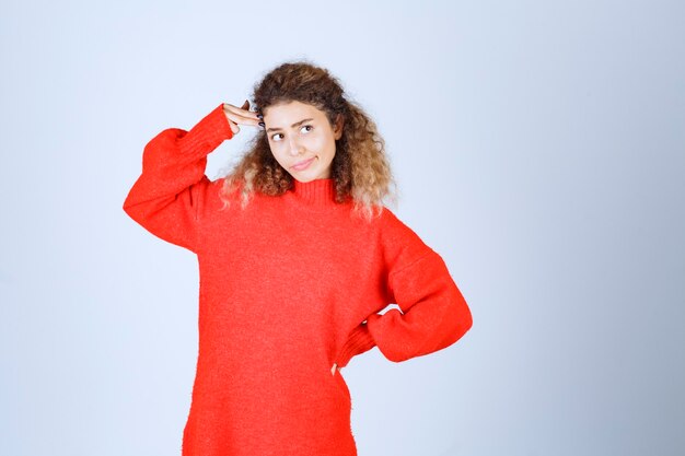 woman in a red shirt looks pessimist or sad. 