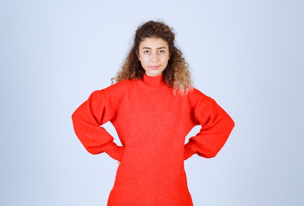 woman in a red shirt looks pessimist or sad.