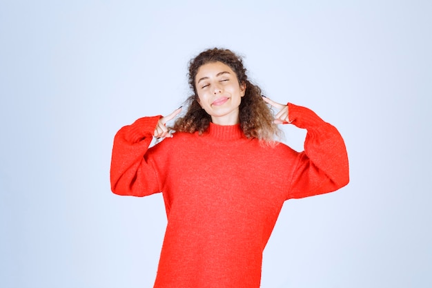 woman in red shirt pointing at herself. 