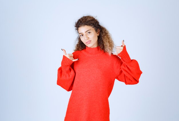 woman in red shirt showing call sign. 