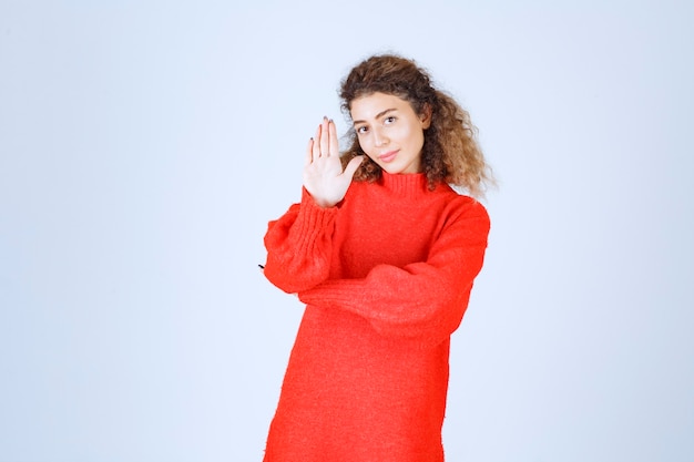 woman in a red shirt stopping and preventing something. 