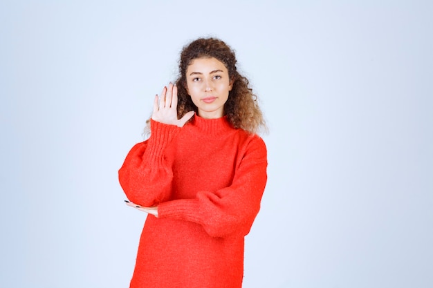 woman in a red shirt stopping and preventing something. 