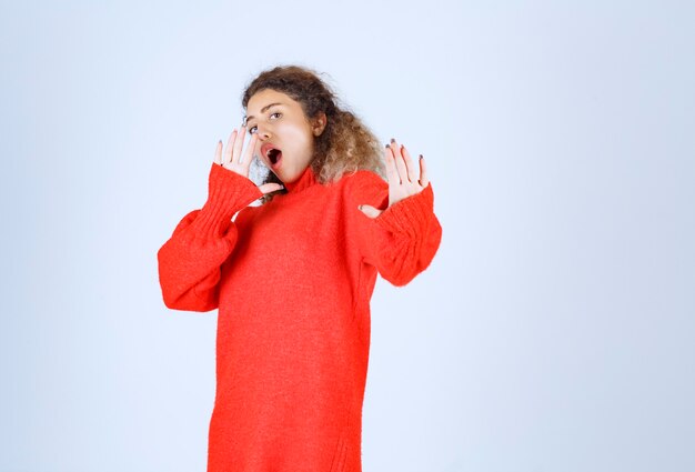 woman in a red shirt stopping and preventing something.