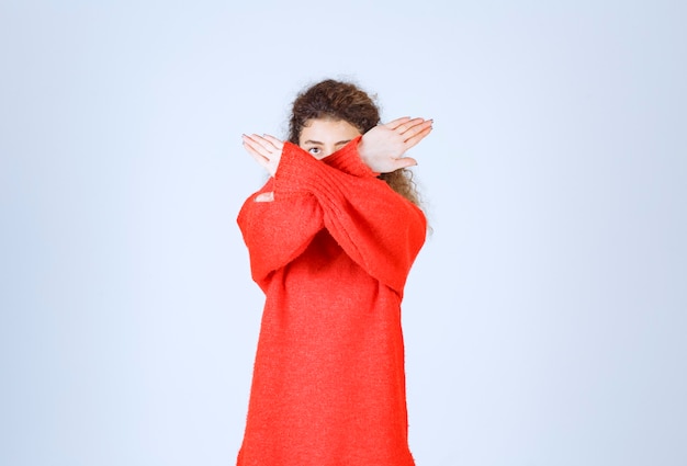 woman in a red shirt stopping and preventing something.