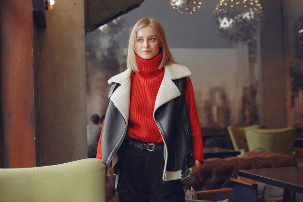 Woman in a red sweater. Lady in a restaurant.