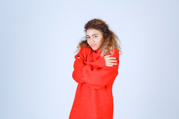 woman in red sweatshirt feeling cold.