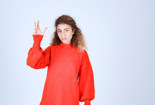 woman in red sweatshirt giving neutral poses. 