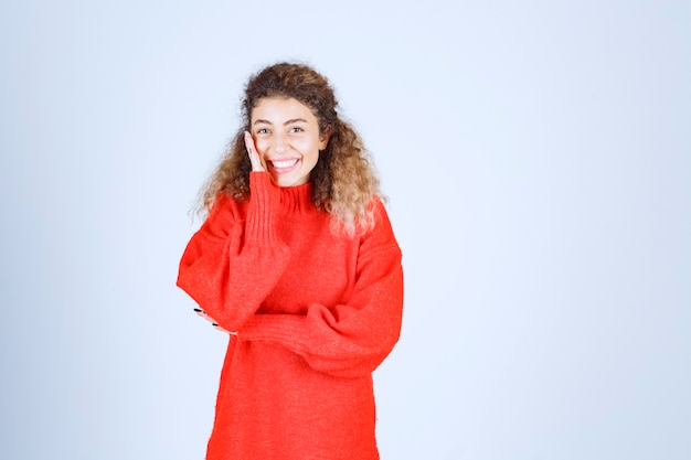 woman in red sweatshirt giving smiling and seductive poses. 