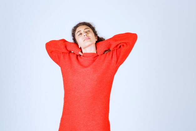 woman in red sweatshirt looks tired and sleepy.