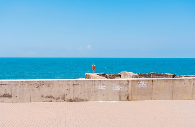 A woman in a red swimsuit and the sea