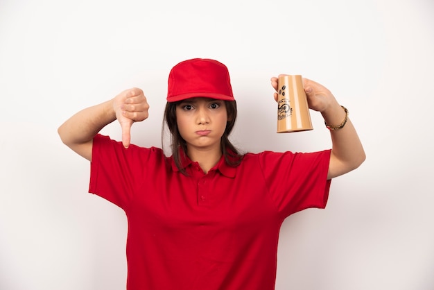Woman in red uniform with empty cup showing thumb down