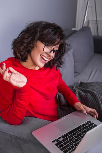 Woman in red using laptop