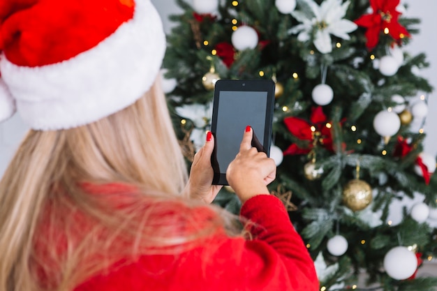 Woman in red using tablet