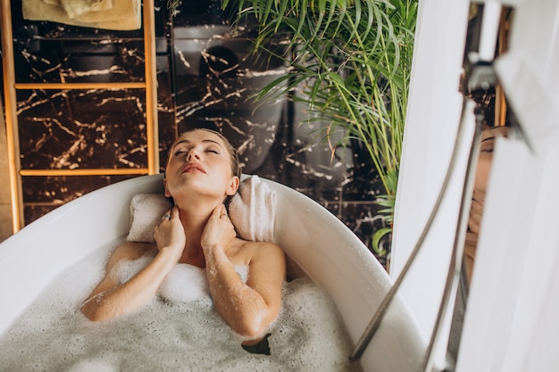 Free photo woman relaxing in bath with bubbles