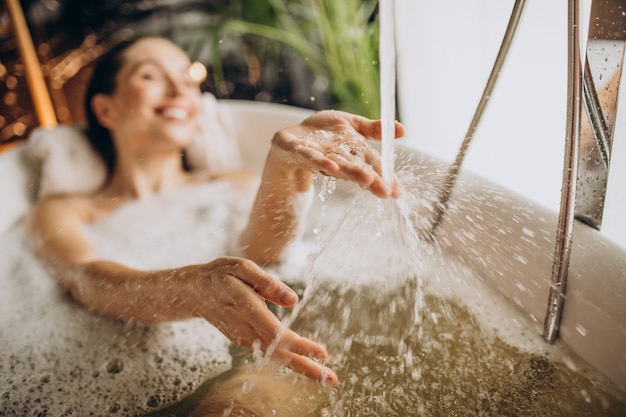 Женщина, расслабляющаяся в ванне с пузырьками
