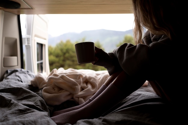 Woman relaxing in her camper in daylight