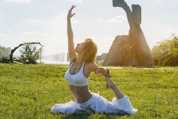 Woman relaxing and stretching on lawn