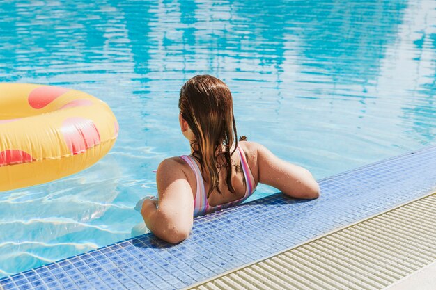 Woman relaxing next to swimming pool