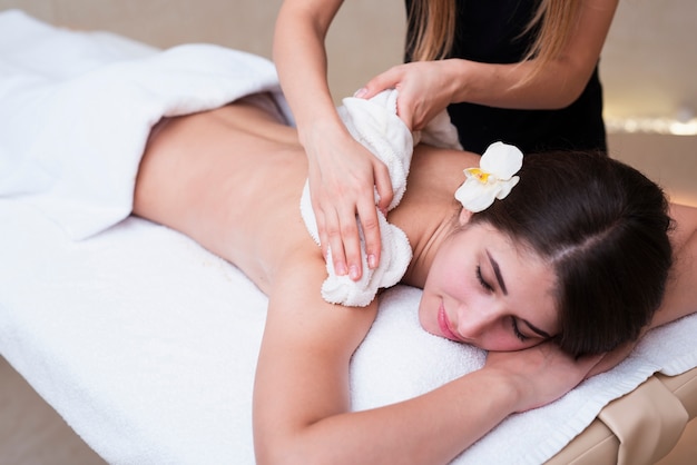 Woman relaxing while getting spa treatment