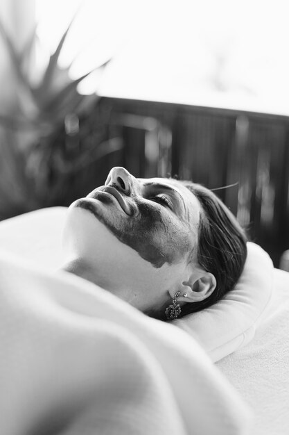 Woman relaxing with a facial mask at the spa