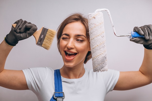 Woman repairer with painting roller isolated