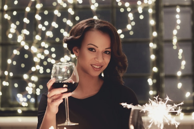 Woman in restaurant holding a wine glass