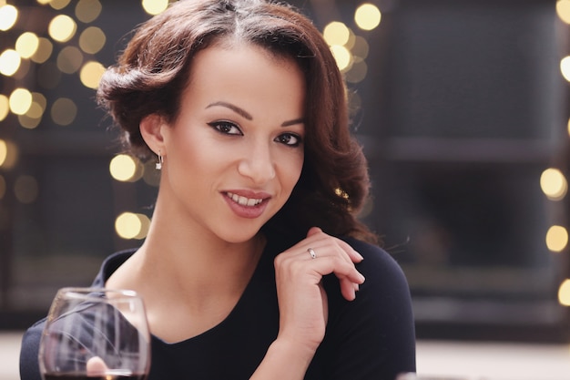 Woman in restaurant holding a wine glass