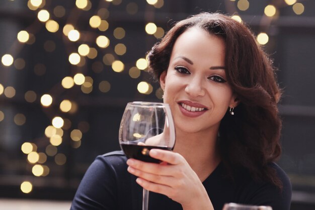 Woman in restaurant holding a wine glass