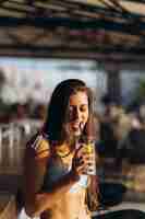 Free photo woman resting on the beach bar drink a refreshing cocktail