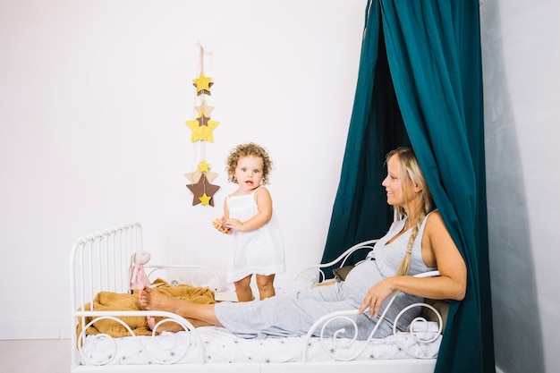 Woman resting in bed near baby