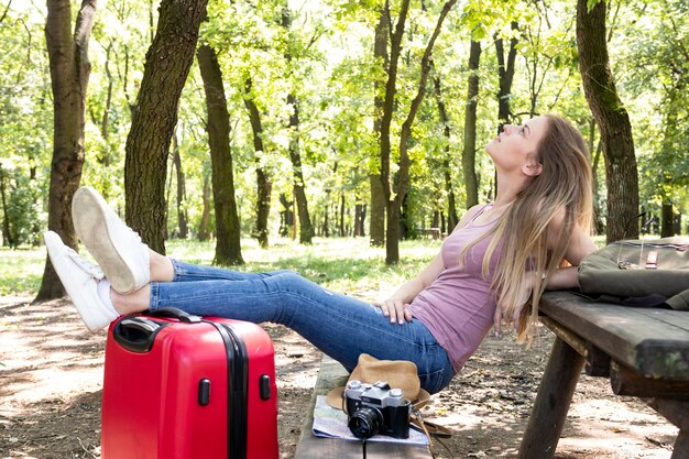 Woman resting on a bench profile view