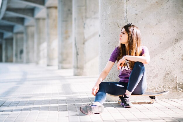 Woman resting on skateboard