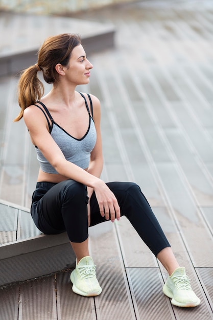 Free photo woman resting while exercising outdoors