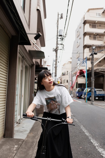 Woman riding electric scooter in the city