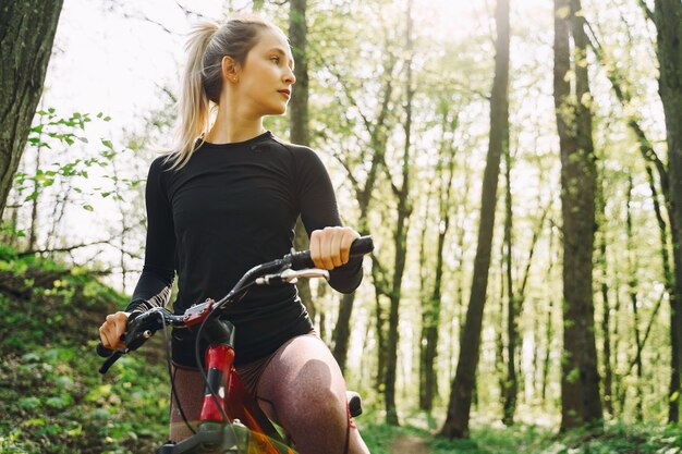 Woman riding a mountain bike in the forest