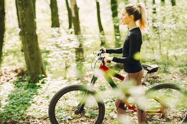 Woman riding a mountain bike in the forest