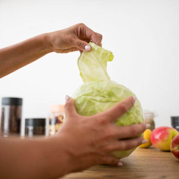 Woman ripping leaves from a cabbage