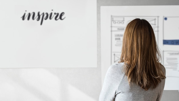 Free photo woman in a room creating inspirational content