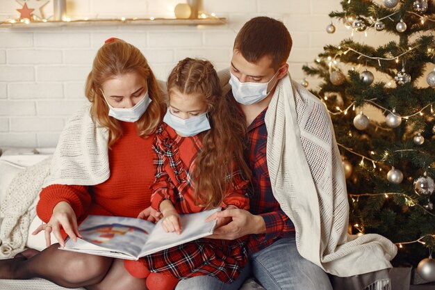 Woman in a room. Girl in a white sweater. Lady near christmas tree.