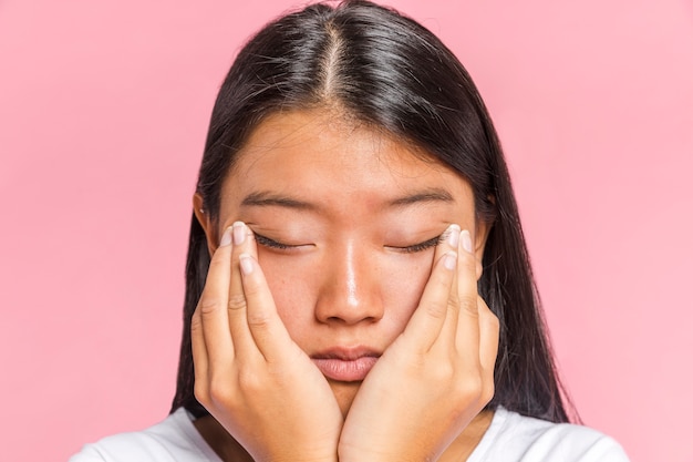 Woman rubs her eyes close-up