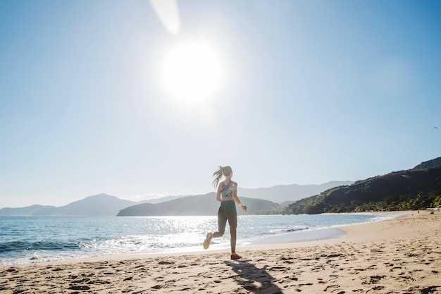 Woman running alone on the beach