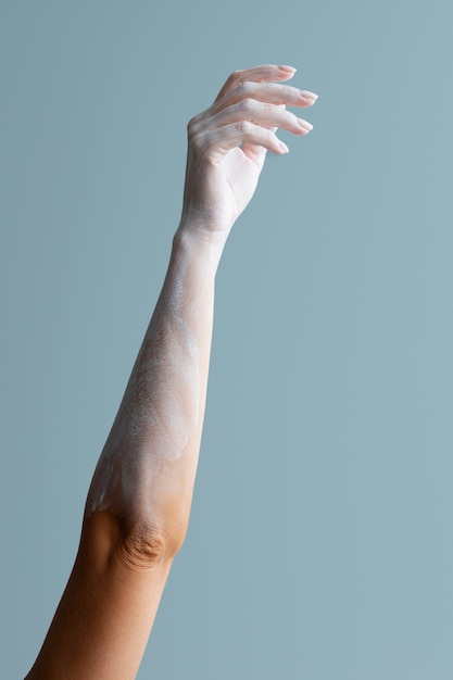 Woman's arm with white powder posing