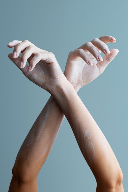 Woman's arms posing with white powder