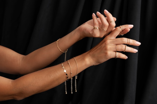 Woman's arms wearing golden jewelry