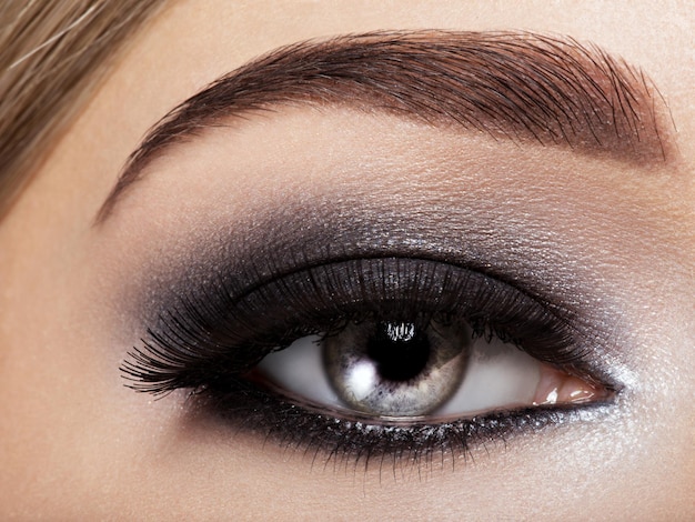 Woman's eye with black eye makeup. Macro style image. Long eyelashes