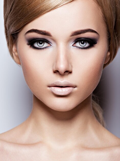 Woman's face with  fashion black makeup of eye and long black eyelashes.