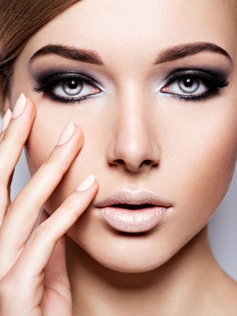Woman's face with  fashion black makeup of eye and long black eyelashes.