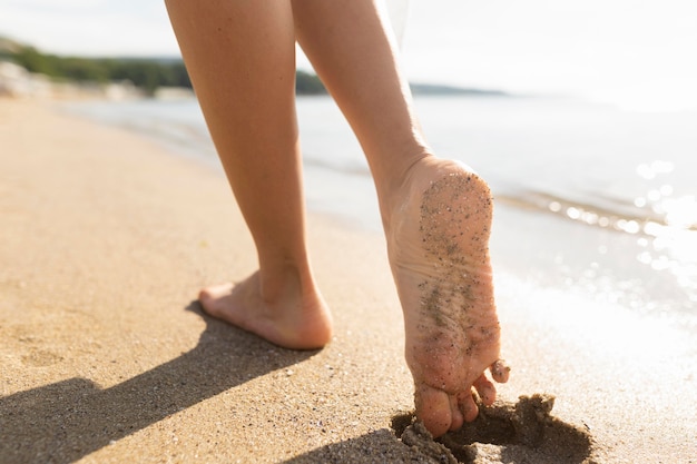 woman's feet on beach sands